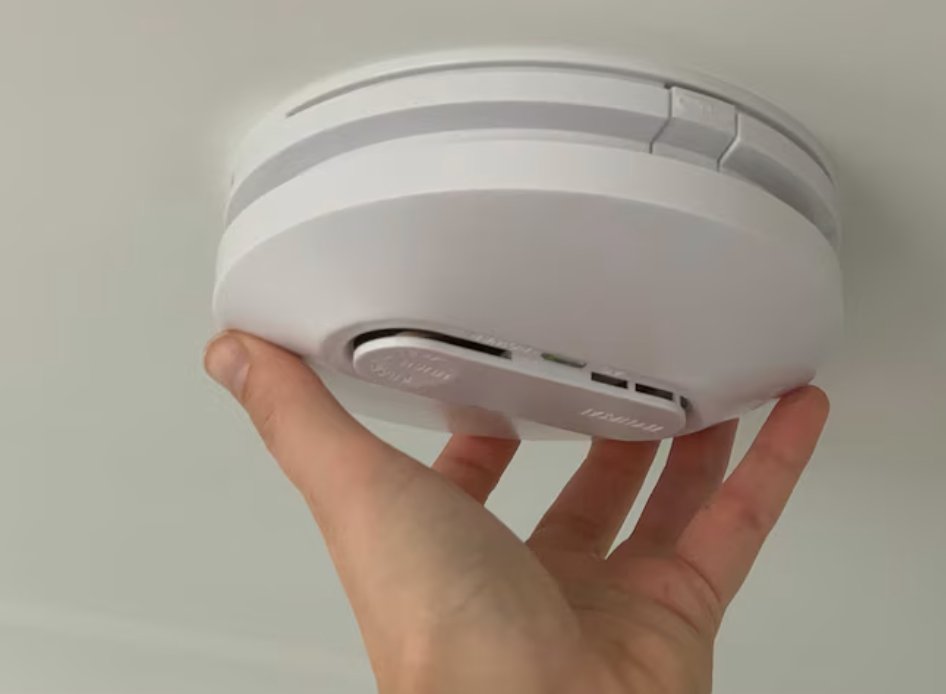 Installing a smoke alarm on a ceiling